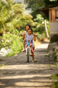 Sumatran kids riding bike